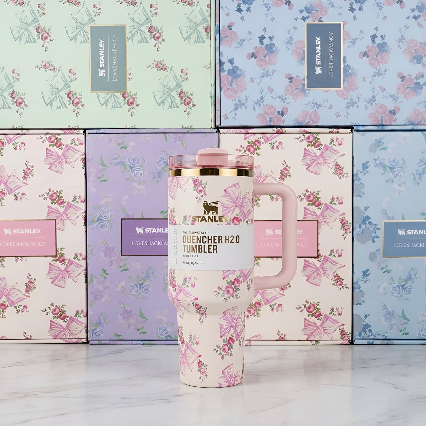 Pink floral patterned stanley quencher h2o tumbler with gold rim and matching pink lid 40 oz 1200 ml