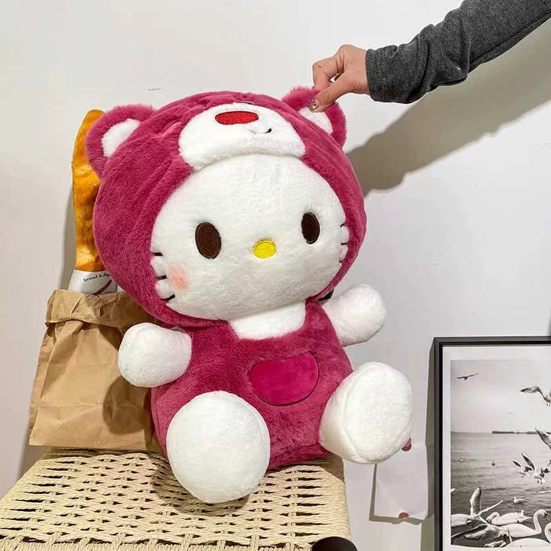 Plušasta Hello Kitty u ružičastom kostimu medvjedića na Hello Kitty plišanom jastuku