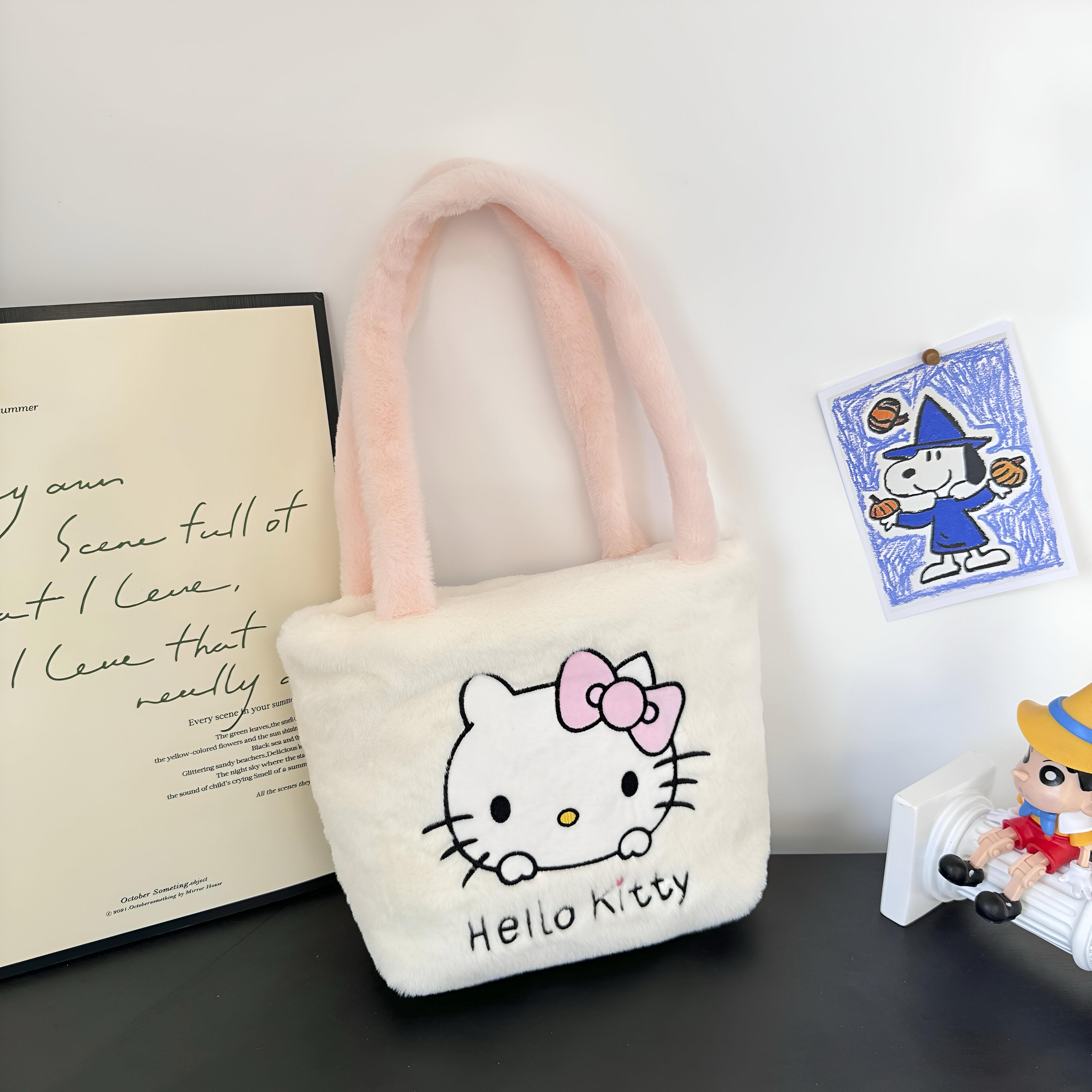 Fuznata bijela Hello Kitty torbica s ručkama u roznoj boji
