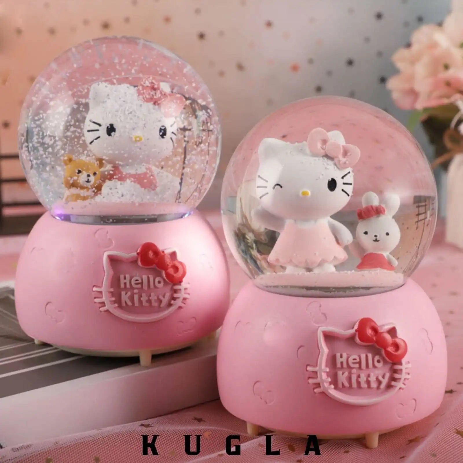 Dva ružičasta Hello Kitty snježna globusa.