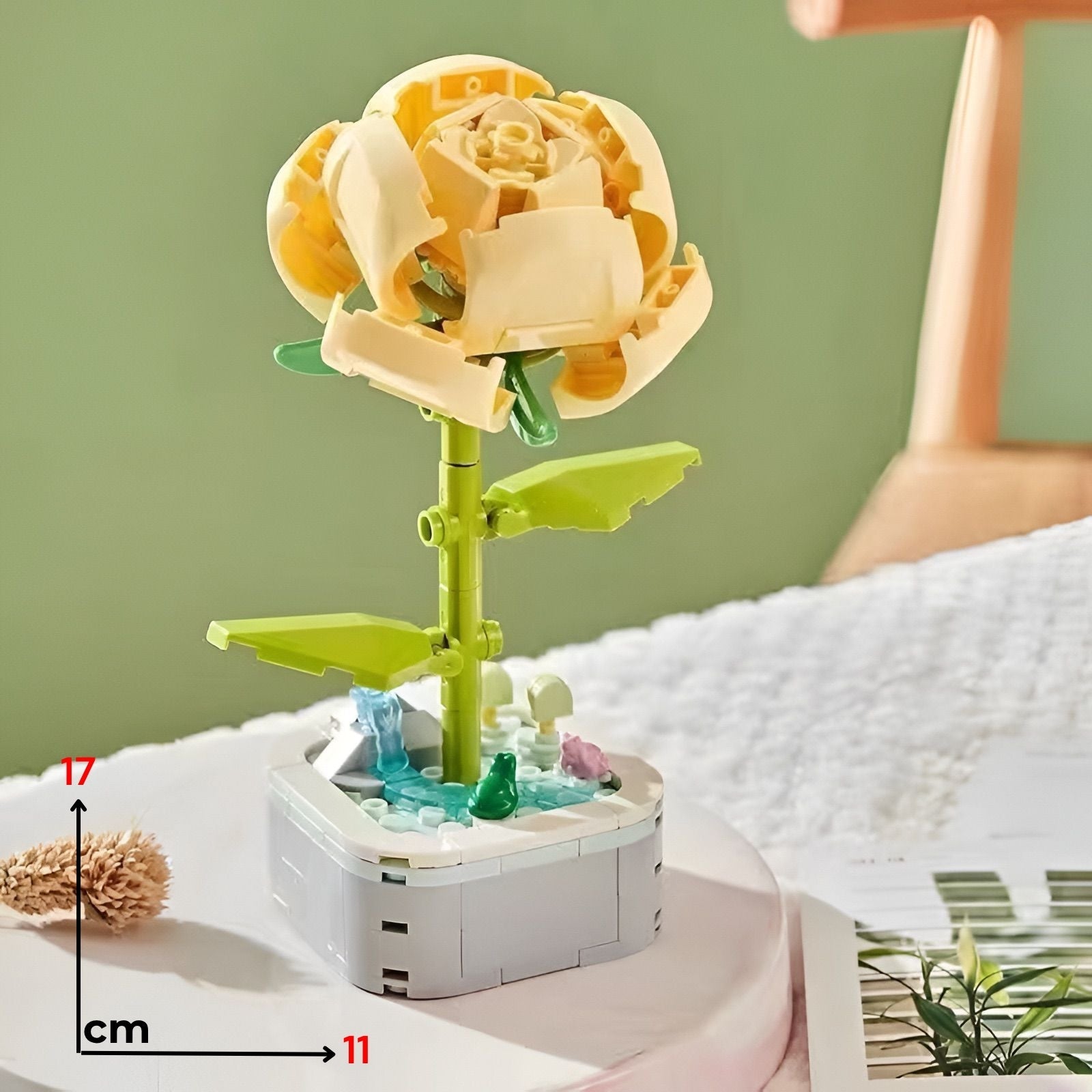 Cream-color lego rose with green stem and leaves on white base with miniature garden elements divlja ruža lego