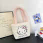 Fuznata bijela Hello Kitty torbica s ručkama u roznoj boji