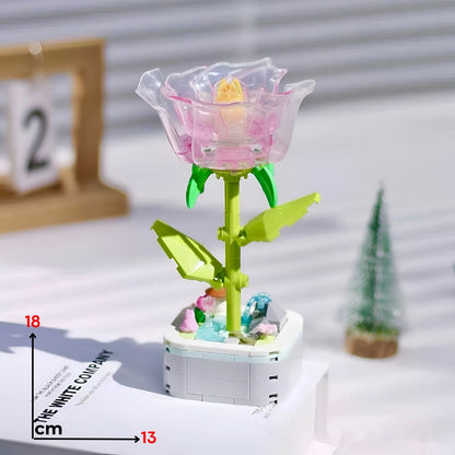 Translucent pink lego kristalna ruža with yellow center green stem leaves assembled on white base