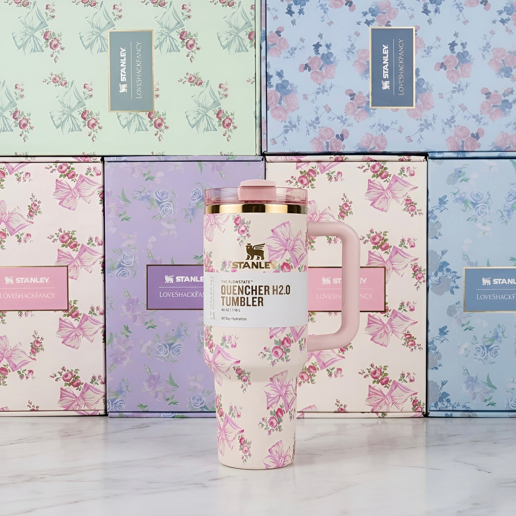 Pink floral patterned stanley quencher h2o tumbler with gold rim and matching pink lid 40 oz 1200 ml