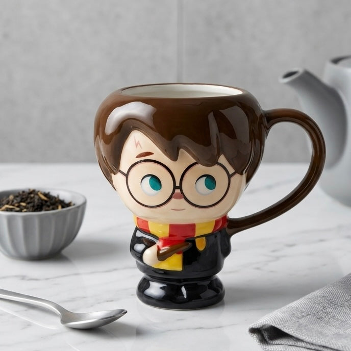 Glossy brown ceramic harry potter šolja shaped like a figure with glasses red and yellow scarf and holding a wand