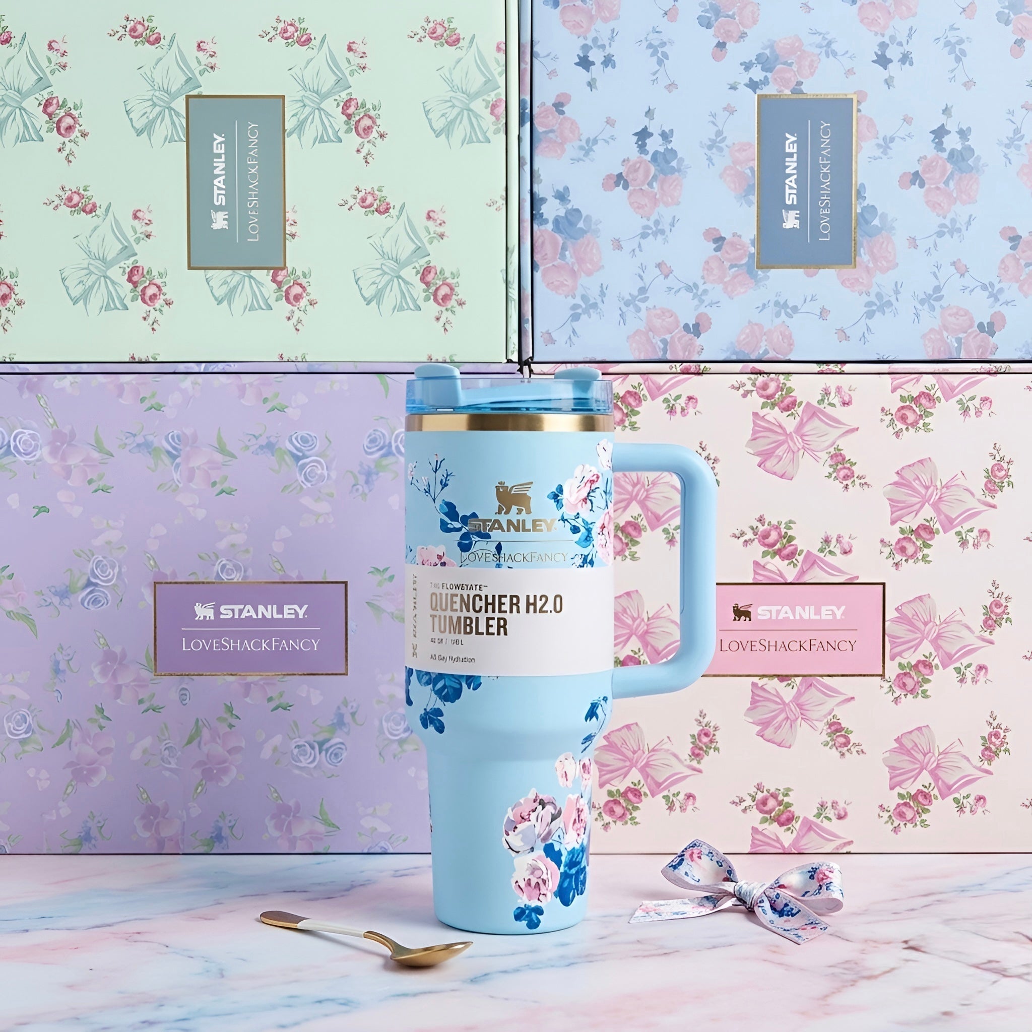 Light blue floral stanley quencher h2o tumbler with gold-trimmed lid and matching handle 40 oz 1200 ml modelo boca